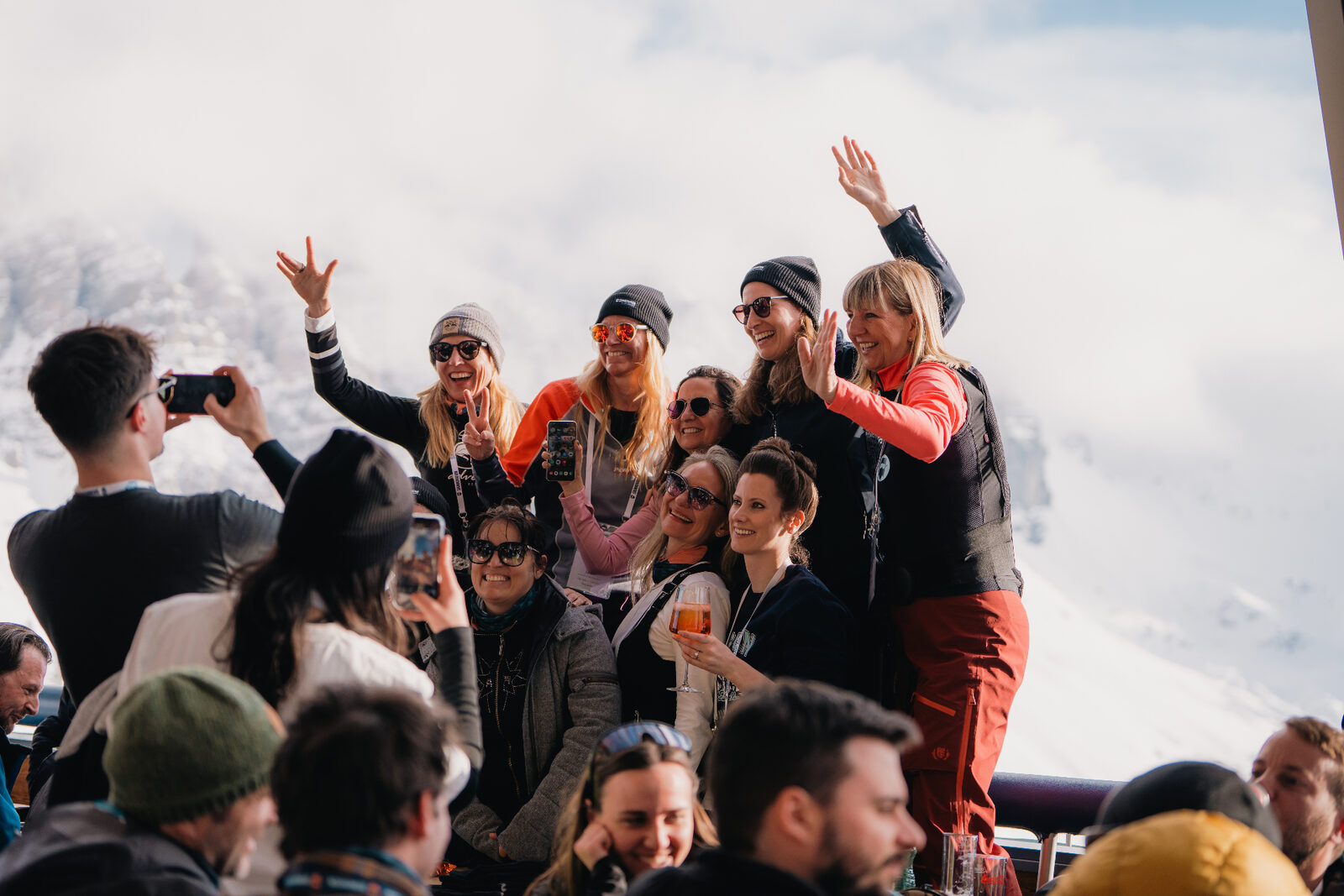 SKInnovation attendees cheering together on a sunny mountain terrace at Hoadlhaus
