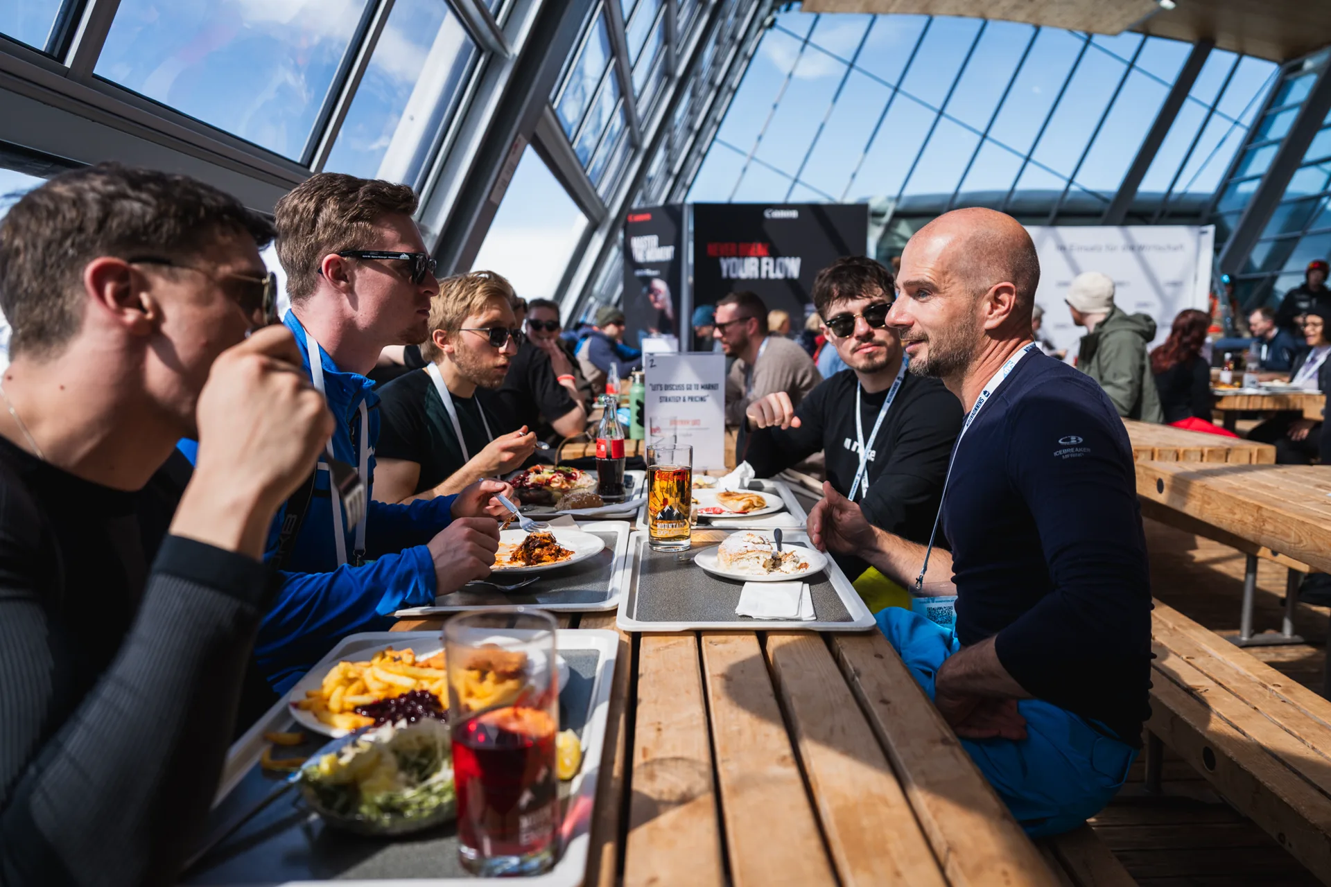 Community group gathered around lunch tables in Axamer Lizum