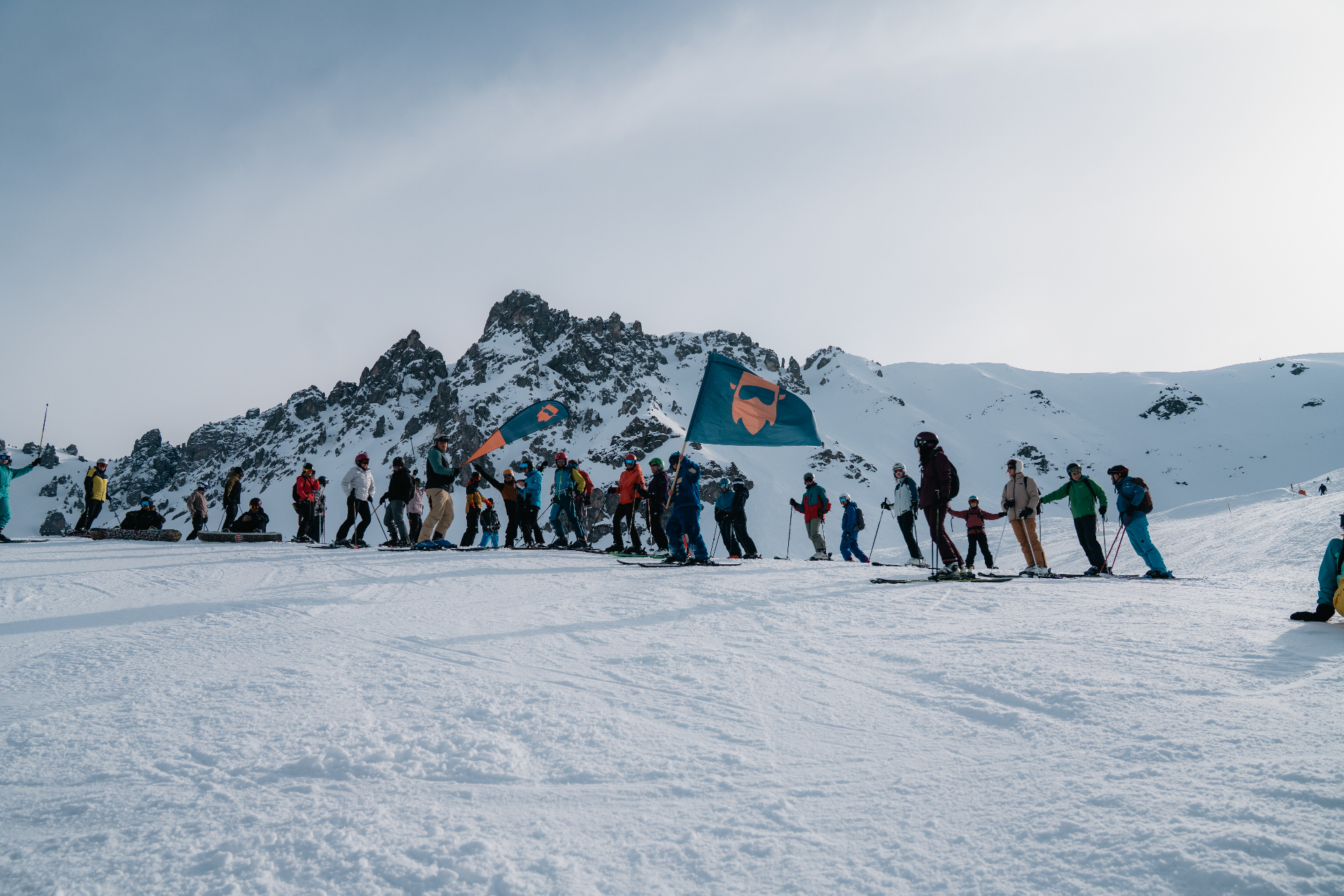 SKInnovation community with the brand flag in front of the Axamer Lizum ridge