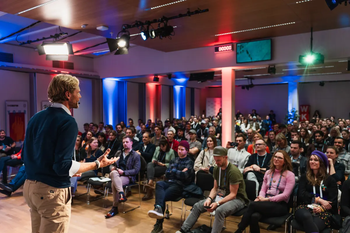 Speaker in front of a full audience at SKInnovation 2024